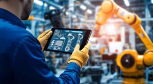 man controlling robot with iot manufacturing solution